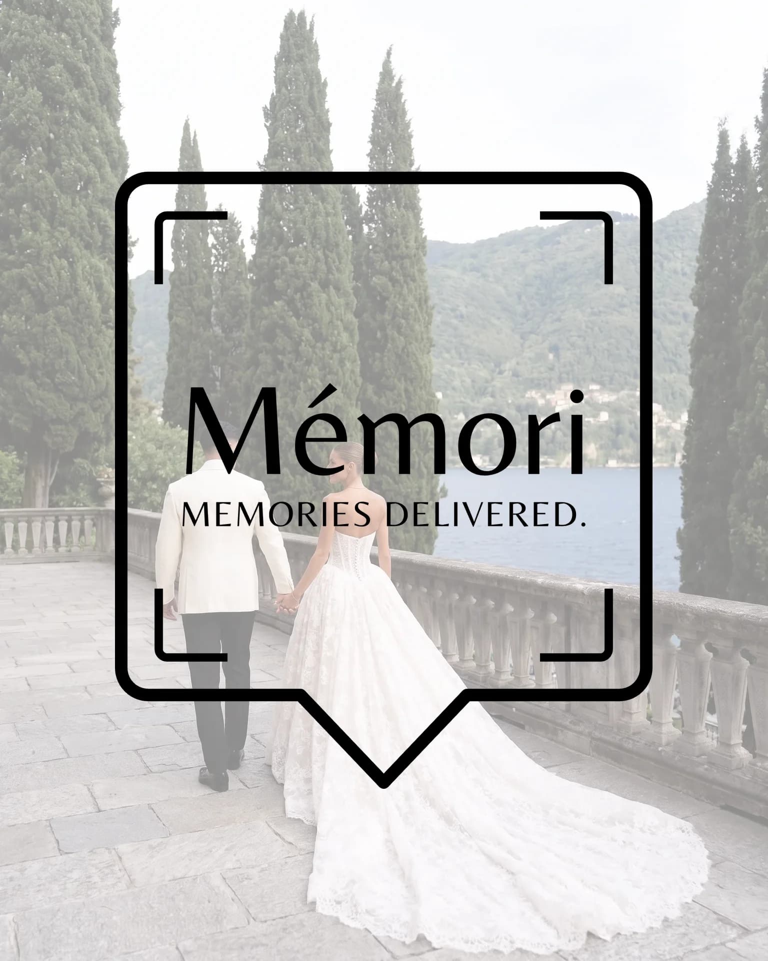 Bride and groom on a lakeside terrace with the Mémori logo